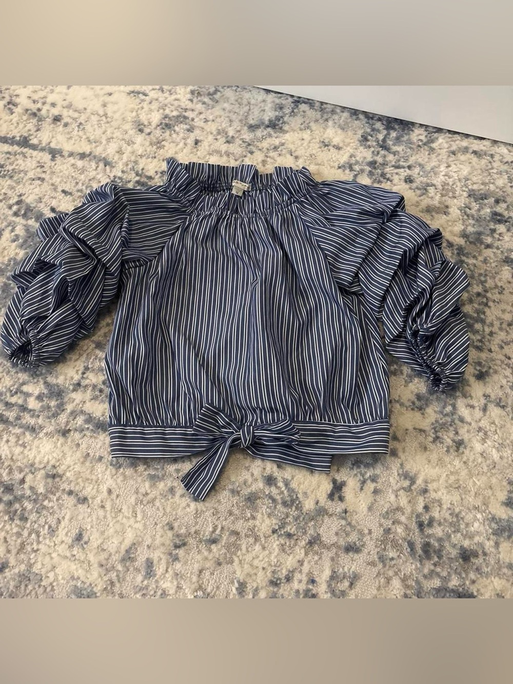 Blue and white vertical striped blouse with ruffled sleeves and tie waist